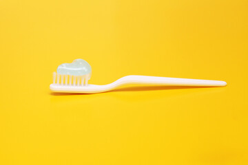 Toothbrush and toothpaste on blurred background