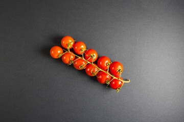 Cherry tomatoes in container isolated on black background
