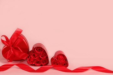 The concept of Valentine's Day or Women's Day. Greeting card, red hearts and gift boxes on a pink background, place for text, banner, Happy holidays, congratulations, birthday, selective focus