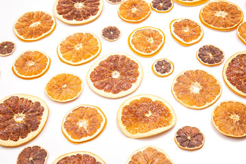 mix of different pieces of dried citrus fruit on white background