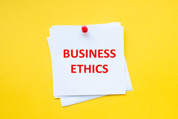 word business ethics on white sticker with yellow background