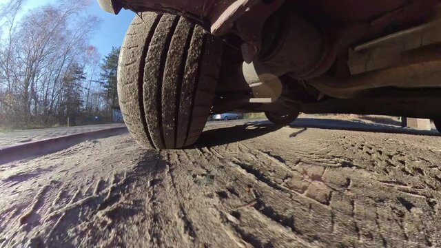 Car Tyre and Suspension System When Driving on Dirt Road Wide Angle POV