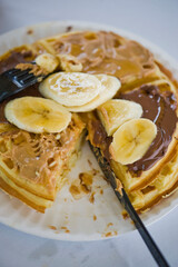 Waffles. Homemade Belgian Waffles topped with an assortment  toppings: peanut butter Nutella fresh fruits, dried fruits, chopped pistachios walnuts and almonds. 