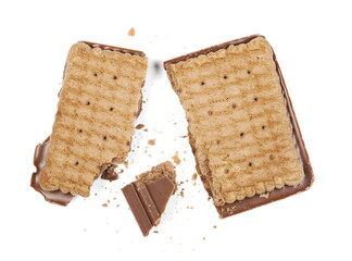 Broken chocolate cookies with crumbs isolated on white background, top view