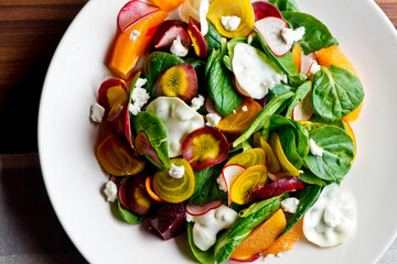 Beet salad. Classic Steakhouse salad made with organic beets, iceberg lettuce, cherry tomatoes, blue cheese dressing, carrots and Italian parsley. Traditional restaurant salad.