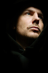 Man on a dark background with a neutral expression. Film grain and noise effect.