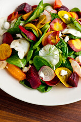 Beet salad. Classic Steakhouse salad made with organic beets, iceberg lettuce, cherry tomatoes, blue cheese dressing, carrots and Italian parsley. Traditional restaurant salad.