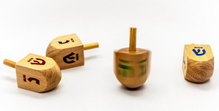 Hanukkah traditional dreidels on the white background. Selective focus.
