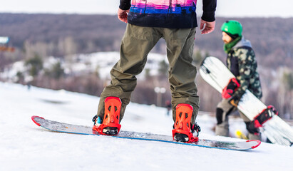 Snowboarders on track in snowy mountains