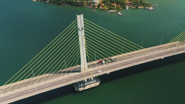 Amazing aerial view bridge traffic above the turquoise color ocean, located in Laguna, Santa Catarina, Brazil