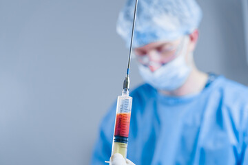 Human fat in a syringe close-up. Liposuction for lipofilling surgery operation. Plastic operation...