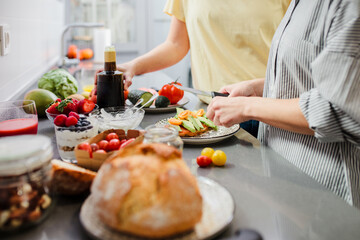 Women preparing healthy food in kitchen having fun, concept dieting nutrition.