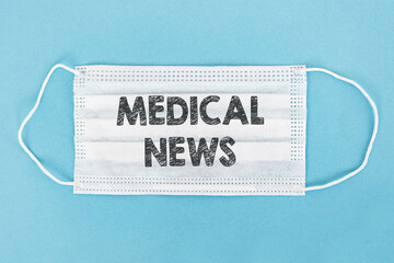 Medical face mask with MEDICAL NEWS text on blue background.