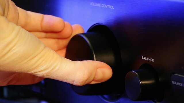 A woman's hand puts sound volume down and makes quieter closeup