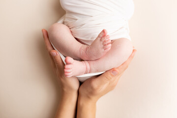 feet newborn in the arms of the mother . feet of a newborn baby. little foot