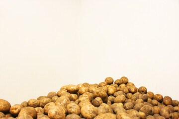 Fresh organic potatoes on a tray at a farmers market, selective focus. isolated on white background. A pile of organic 
