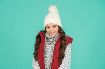 happy teen girl with long curly hair wear puffer waistcoat and knitwear on christmas holidays,...