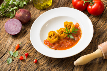 pasta with basil on wooden table