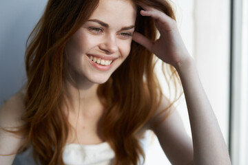 pretty smiling woman near window at home morning rest