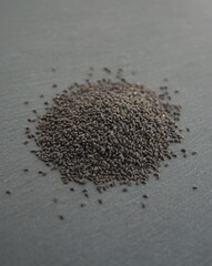 Basil seeds, dietary product (fiber, a good source of minerals, rich in plant-based omega-3 fat), on dark grey background