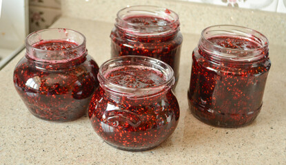 Fototapeta na wymiar Rasberry jam in glass jar and fresh raspberries 