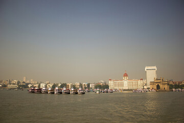 Naklejka premium Mumbai, India - October 23, 2018: Panoramic shot of Gateway of India and Taj hotel by the sea coast located in Apollo Bandar, Colaba in Maharashtra state