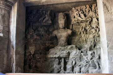 Mumbai, India - October 28, 2018: An interior of UNESCO certified Elephanta cave with god sculpture carved on a wall in 5th century. Ancient Indian art and culture