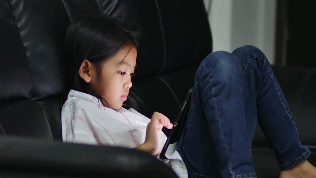 Asian baby joy to play games on tablet
