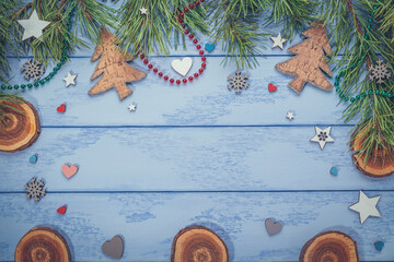 Christmas or New Year flat lay: pine branches and some decorations on the blue boards