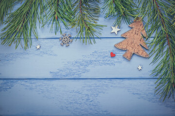 Christmas or New Year mock up with empty space: pine branches, wooden Christmas tree and some decorations on the blue boards