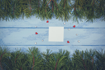 Christmas or New Year mock up: pine branches and white sticker on the blue boards
