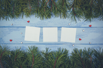 Christmas or New Year mock up: pine branches and white stickers on the blue boards