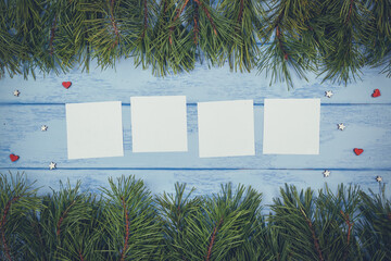 Christmas or New Year mock up: pine branches and four white stickers on the blue boards