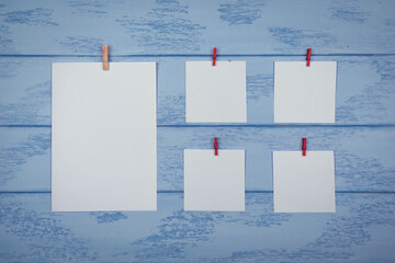 Mock up: white stickers with red clothespins on the blue boards