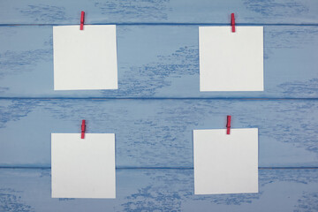 Mock up: white stickers with red clothespins arranged on the blue boards