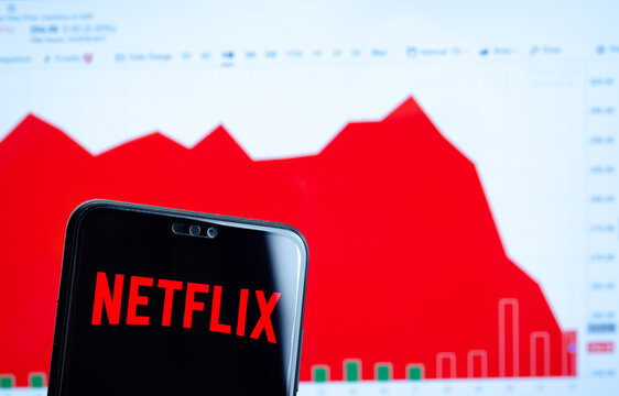 Stone, UK - September 24 2019: Netflix logo on the smartphone screen and the chart with share (NFLX) price for the last month at the blurred background. Netflix stock falls again.