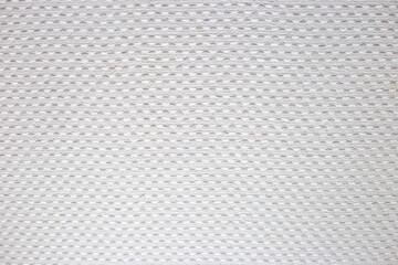 Naklejka na ściany i meble White texture on the wall. Dots in a checkerboard pattern as wallpaper