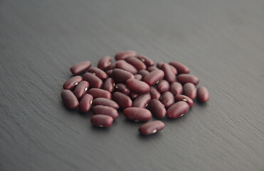 Phaseolus vulgaris, common bean (bush beans, dwarf beans,  pole bean, climbing beans)- herbaceous annual plant, legume family Fabaceae, edible seeds on grey stone background