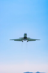 Small plane flying in the clouds on a beautiful sunny day