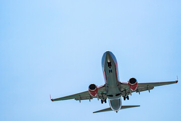 Small plane flying in the clouds on a beautiful sunny day