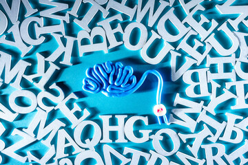 Wire is located in shape of a human brain. Chaotic letters around brain. Concept - brain...