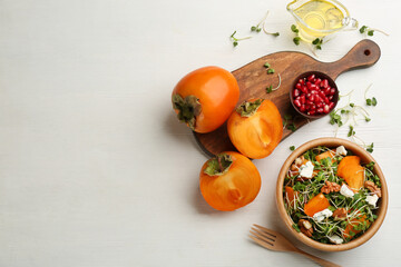 Fototapeta na wymiar Delicious persimmon salad served on white wooden table, flat lay. Space for text