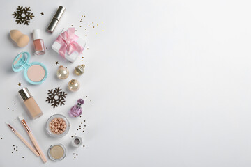 Flat lay composition with decorative cosmetic products on light background. Winter care. Space for text