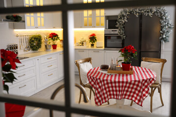 Beautiful kitchen interior with Christmas decor, view through window