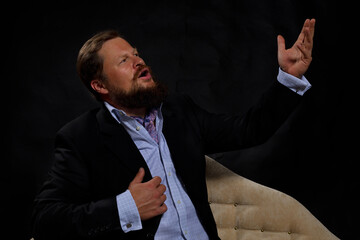 Solid bearded man in suit singing opera studio portrait