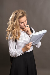 Young beautiful longhaired college girl with papers