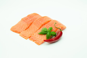 Pieces of fresh Salmon, red chilli pepper, lemon isolated on white