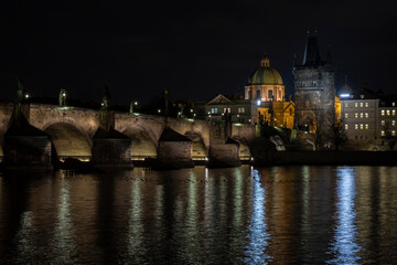 
Charles Bridge and light from street lights in Prague and the level of the Vltava River after sunset in the Czech Republic