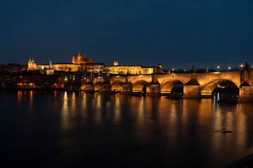 Fototapeta na wymiar . prague castle and charles bridge and st. vita church lights from street lights are reflected on the surface of the vltava river in the center of prague at night in the czech republic
