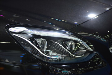Obraz na płótnie Canvas Parts of the new car.Car headlights, headlights, body lights, modern and sporty look.Interior Car seat 